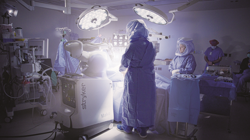 doctors in surgery with robot